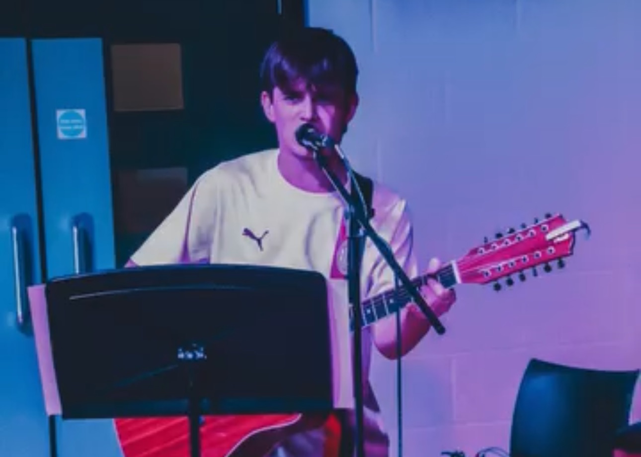 Driveblind live performance on stage with atmospheric lighting and electronic setup